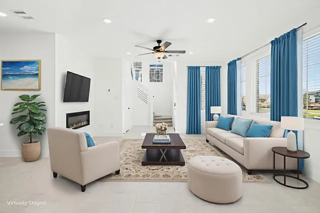 a view of a livingroom with furniture and a ceiling fan