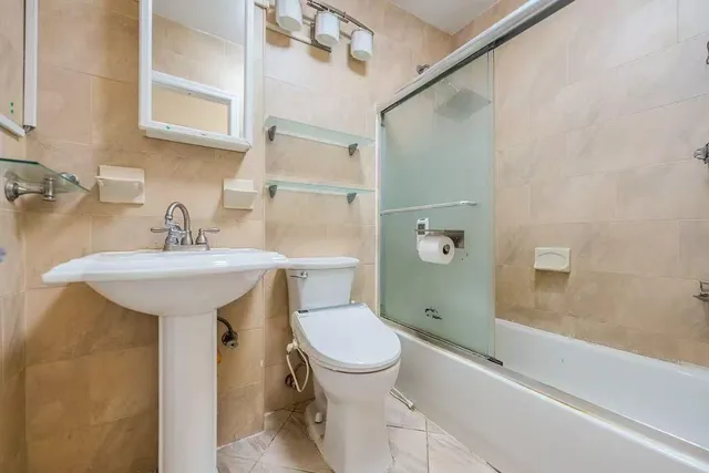 a bathroom with a sink toilet and shower