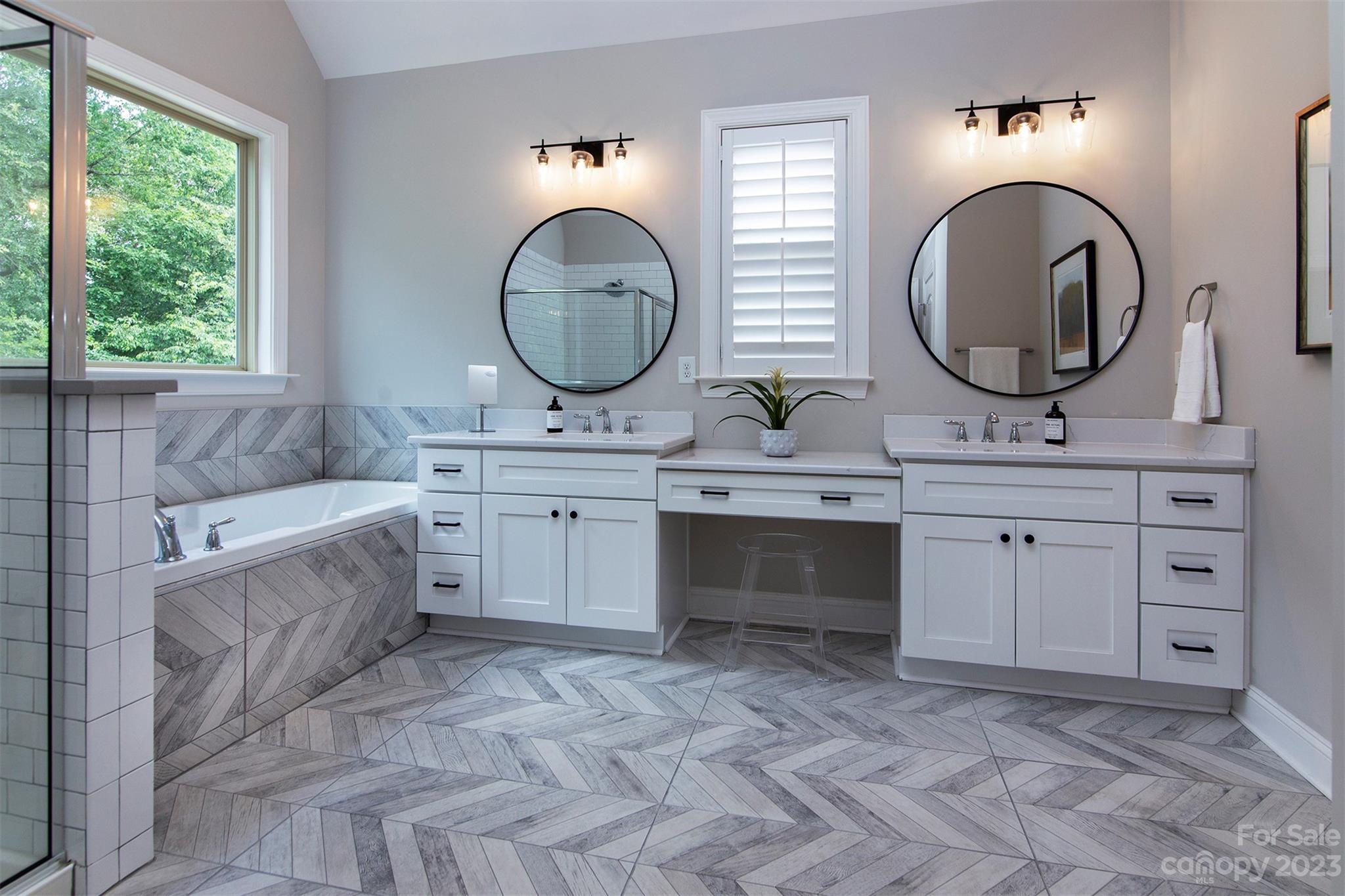 15111 Rocky Bluff Loop Davidson, NC 28036 - Photo 13 of 24 a spacious bathroom with a double vanity sink a mirror and a bathtub