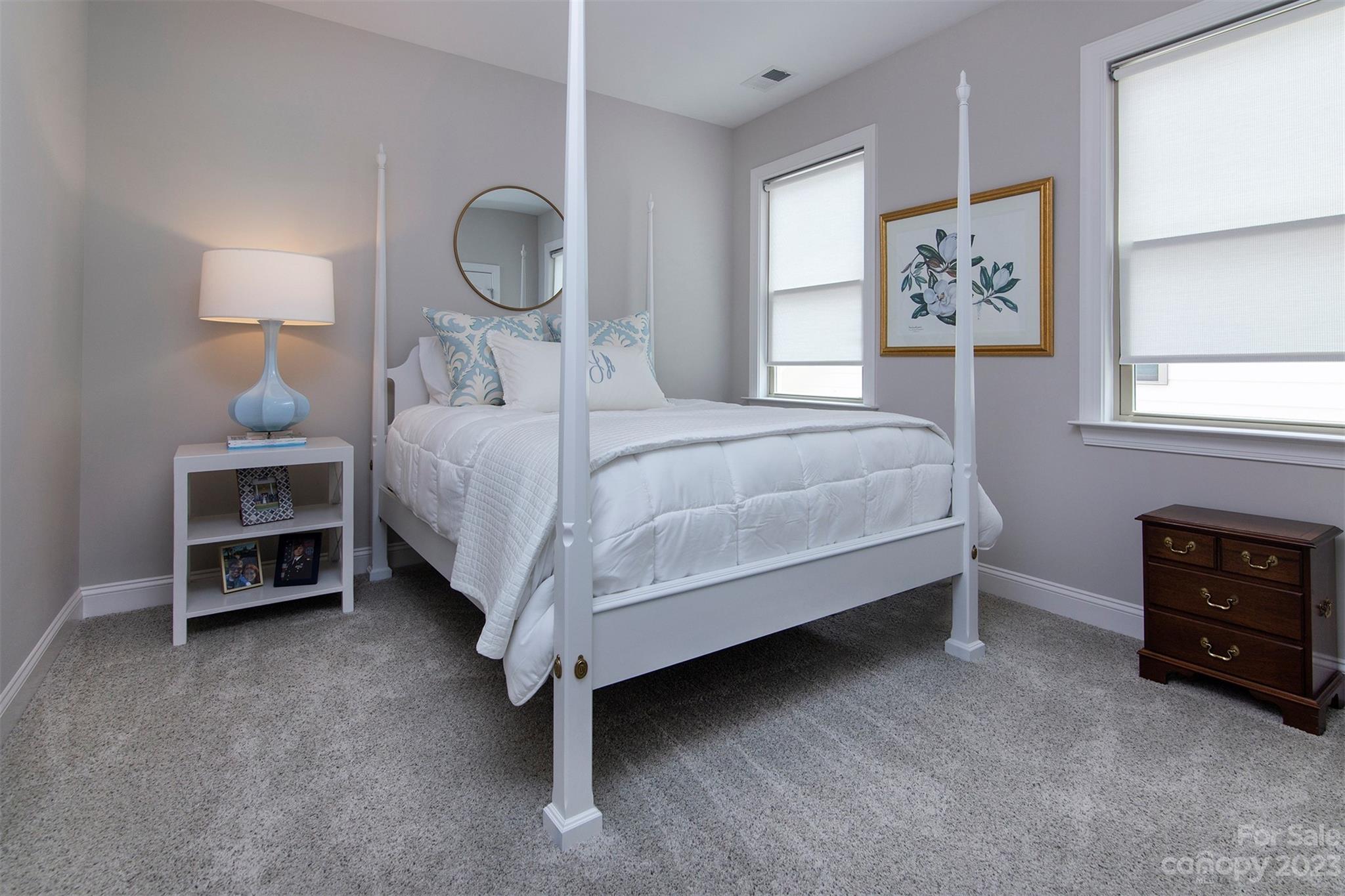 15111 Rocky Bluff Loop Davidson, NC 28036 - Photo 17 of 24 a bedroom with a bed and a chandelier
