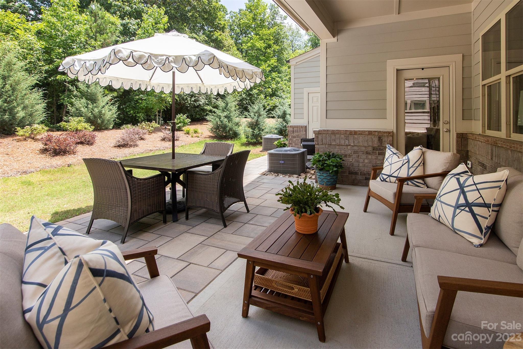 15111 Rocky Bluff Loop Davidson, NC 28036 - Photo 24 of 24 a view of a patio with table and chairs under an umbrella