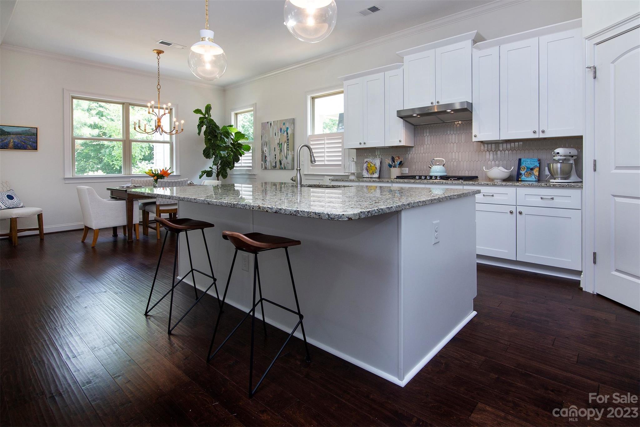 15111 Rocky Bluff Loop Davidson, NC 28036 - Photo 8 of 24 a kitchen with granite countertop sink table and chairs