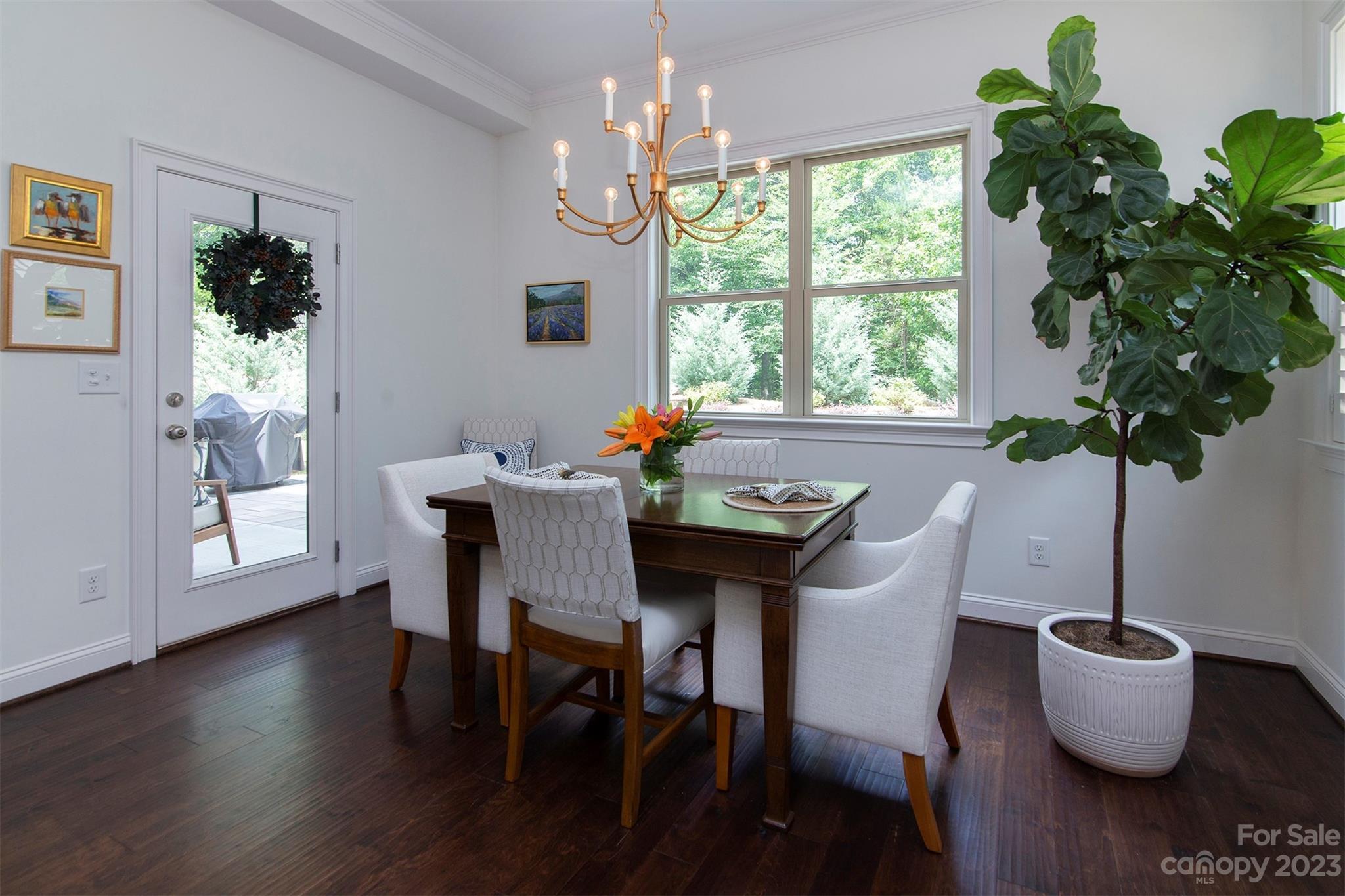 15111 Rocky Bluff Loop Davidson, NC 28036 - Photo 10 of 24 a dining room with furniture potted plants and wooden floor