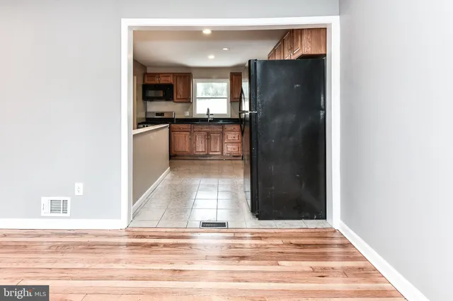a view of kitchen with refrigerator and cabinets