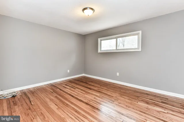 a view of a room with wooden floor and fan