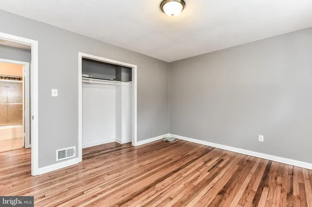 a view of a room with wooden floor