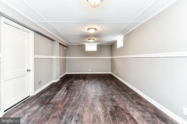 a view of a room with wooden floor