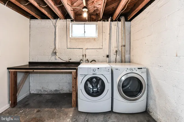 a utility room with sink dryer and washer
