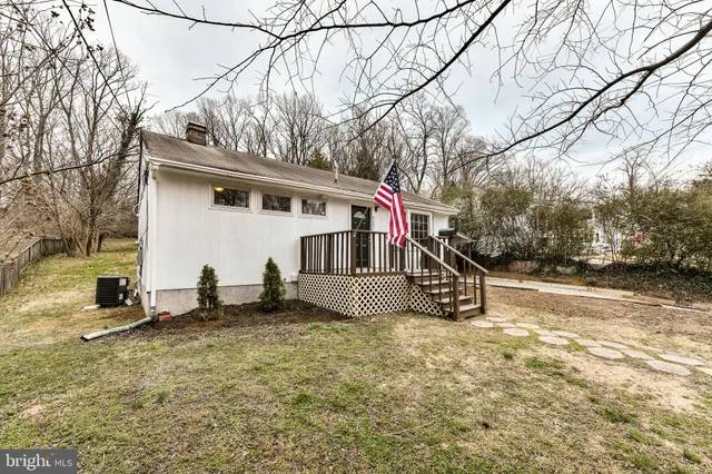 a view of a house with a yard covered in snow
