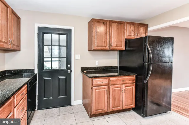 a kitchen with stainless steel appliances granite countertop a refrigerator and a stove
