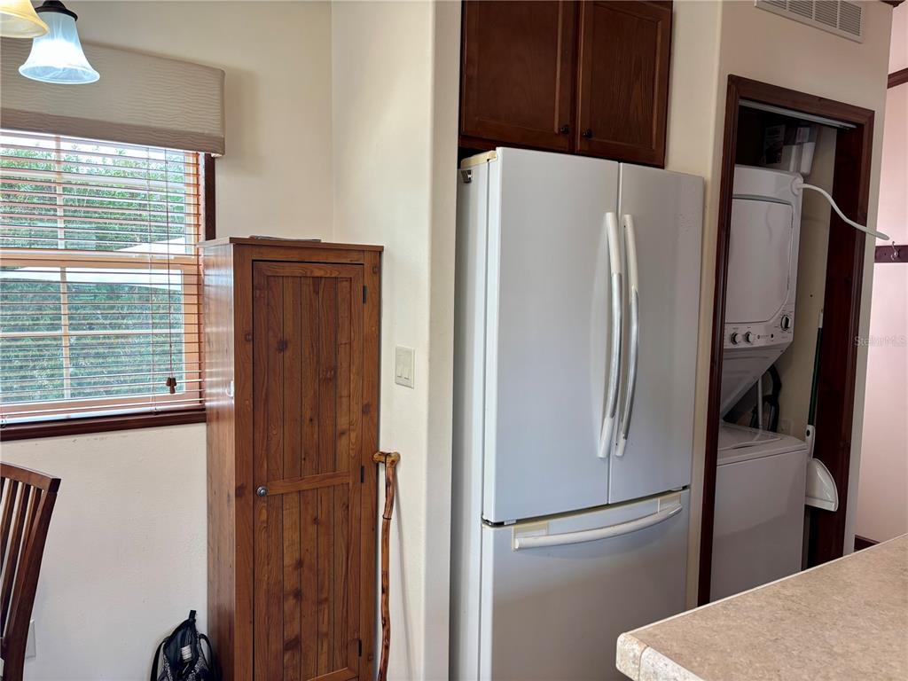 a metallic refrigerator freezer sitting in a kitchen