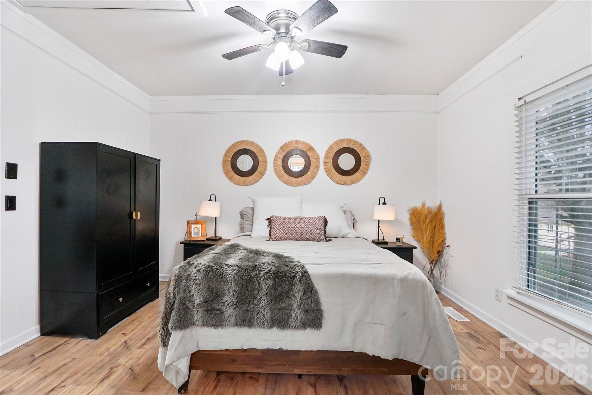 409 Blacksnake Road Stanley, NC 28164 - Photo 11 of 28 a bedroom with a bed and a chandelier