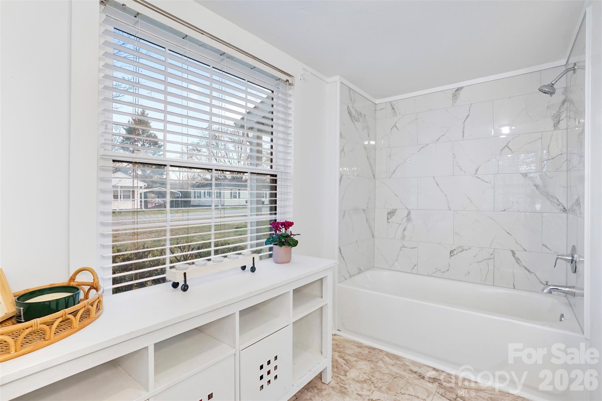 409 Blacksnake Road Stanley, NC 28164 - Photo 12 of 28 a bathroom with a bathtub and a sink