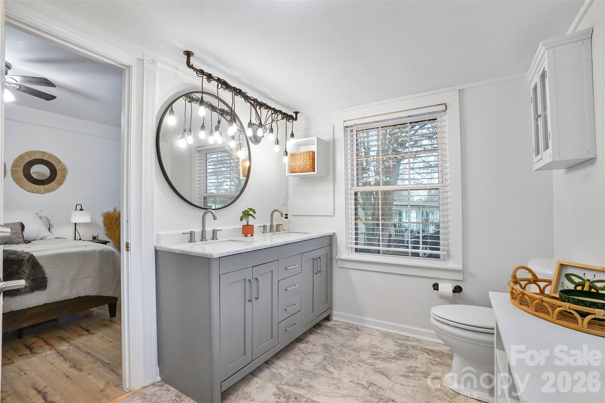 409 Blacksnake Road Stanley, NC 28164 - Photo 13 of 28 a bathroom with a toilet a mirror and a window