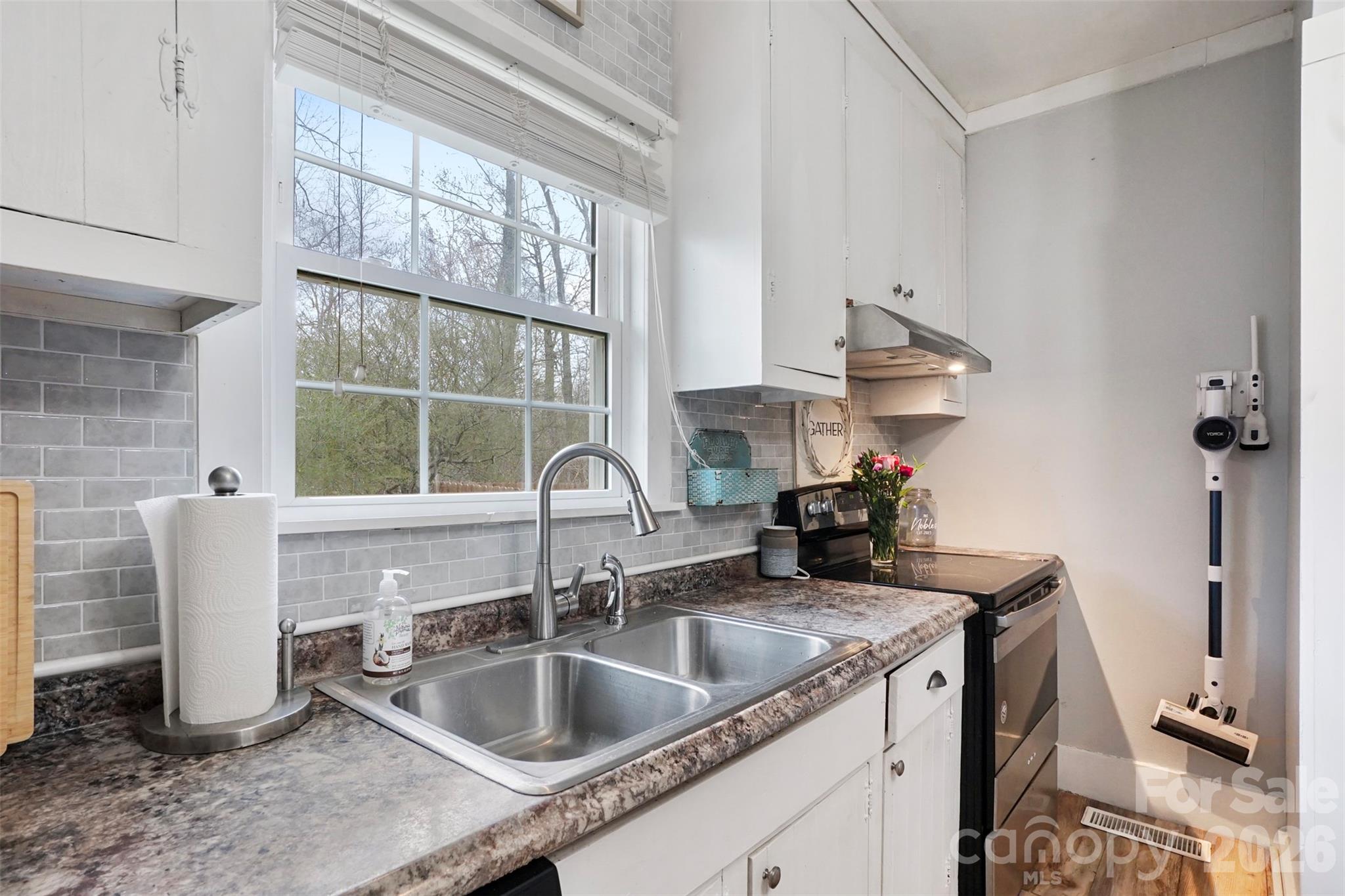 409 Blacksnake Road Stanley, NC 28164 - Photo 18 of 28 a kitchen with a sink and a window