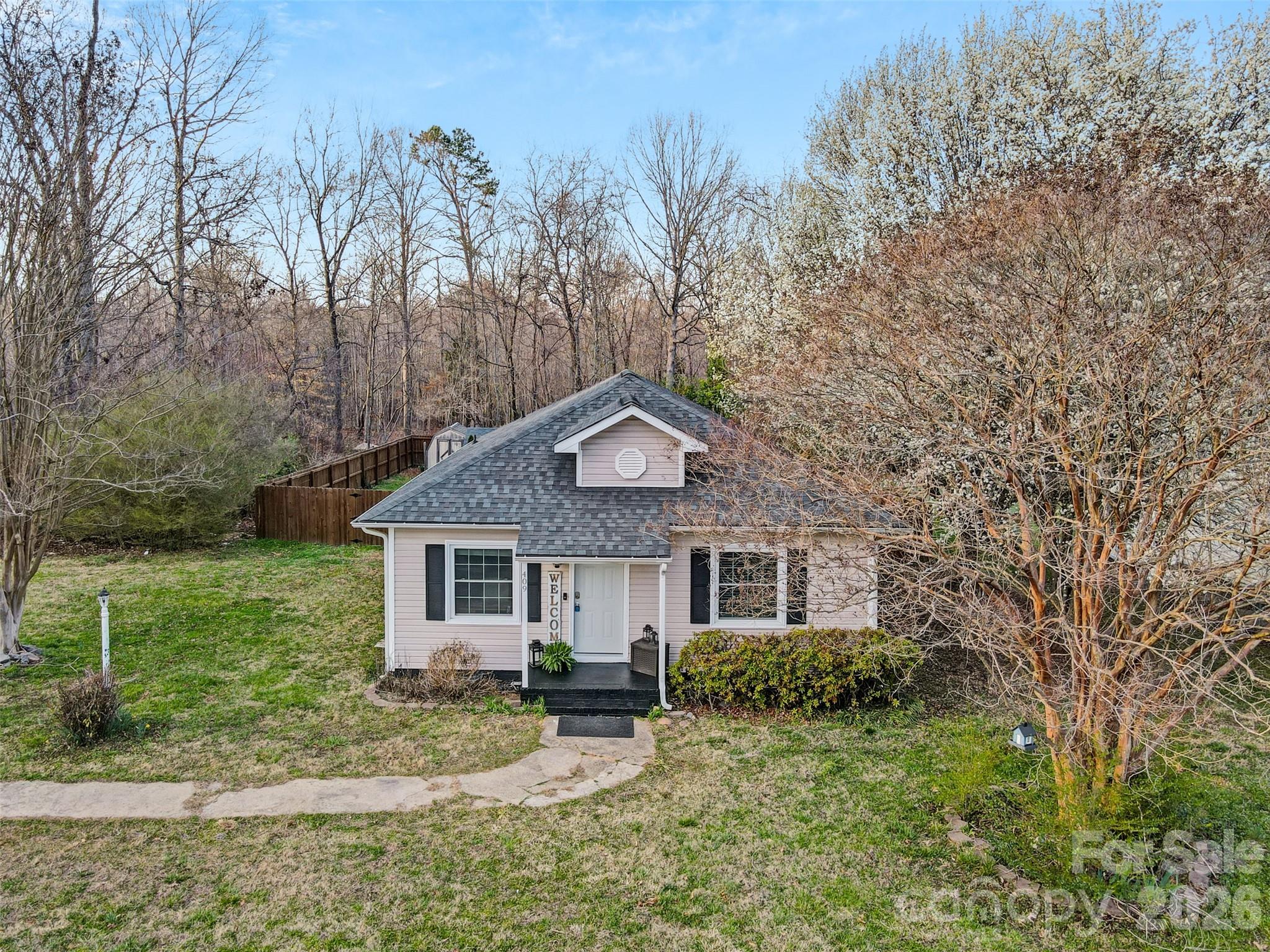 409 Blacksnake Road Stanley, NC 28164 - Photo 2 of 28 a front view of a house with garden