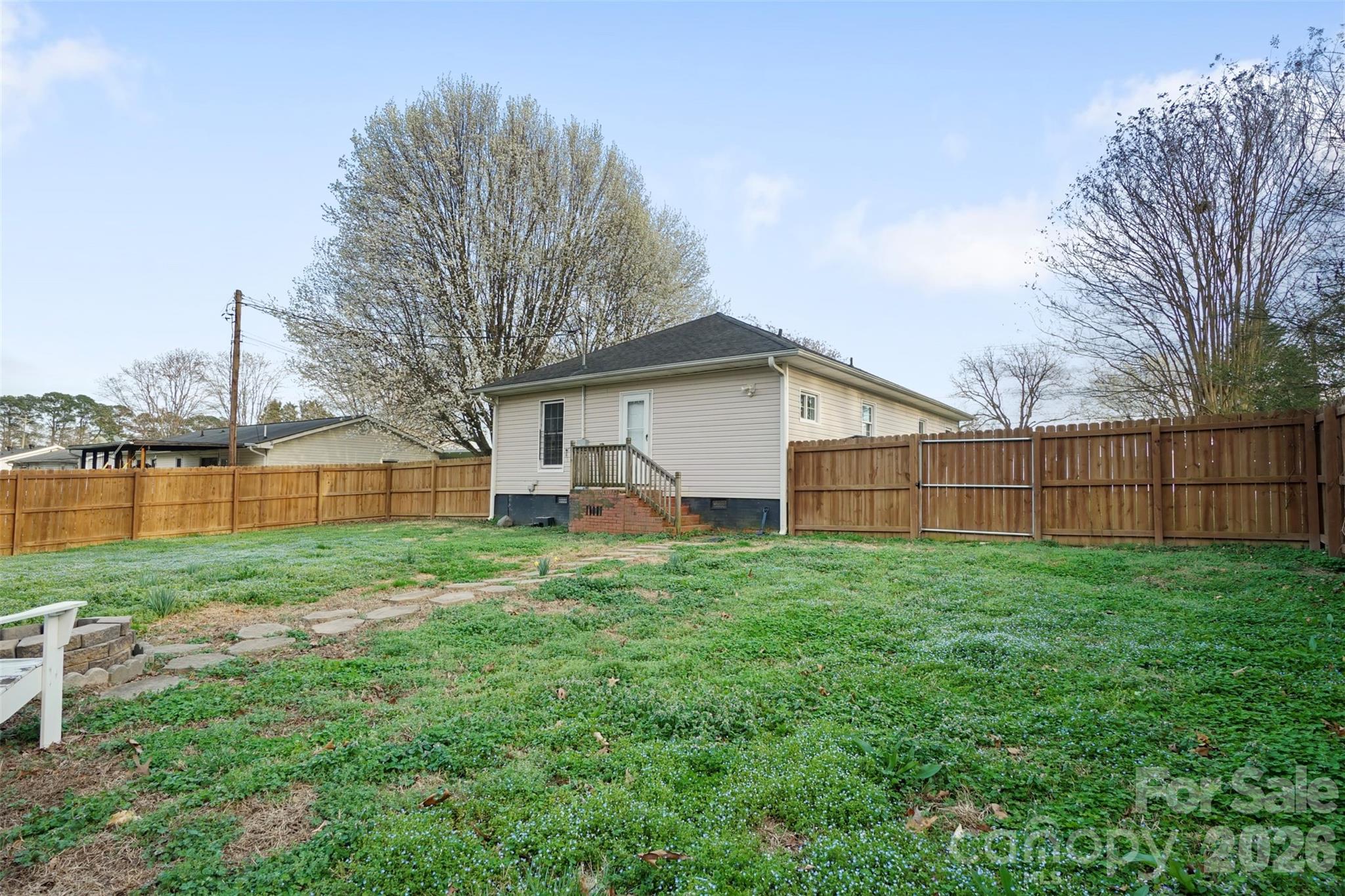 409 Blacksnake Road Stanley, NC 28164 - Photo 22 of 28 a view of backyard with garden and trees