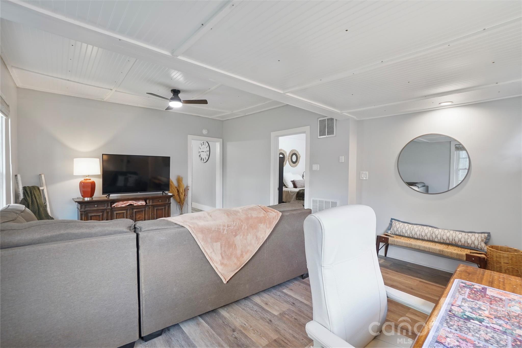 409 Blacksnake Road Stanley, NC 28164 - Photo 7 of 28 a living room with a flat screen tv and a couch