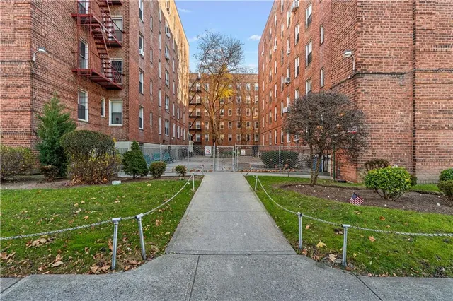 a view of a brick building next to a yard