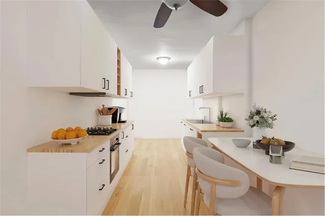 a kitchen with stainless steel appliances granite countertop a sink stove and cabinets