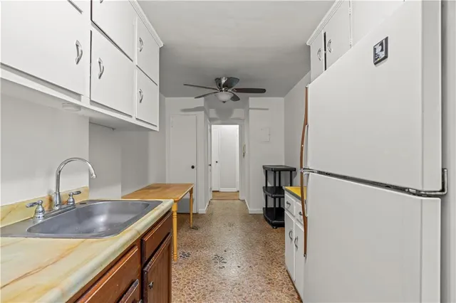 a kitchen with a refrigerator and a sink