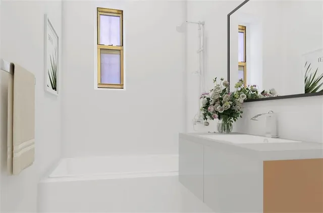 a bathroom with a granite countertop sink a mirror and a shower