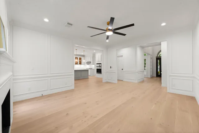 a kitchen with stainless steel appliances kitchen island granite countertop a sink and refrigerator