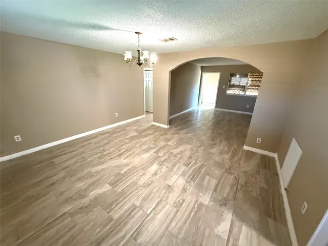 wooden floor in an empty room with a mirror