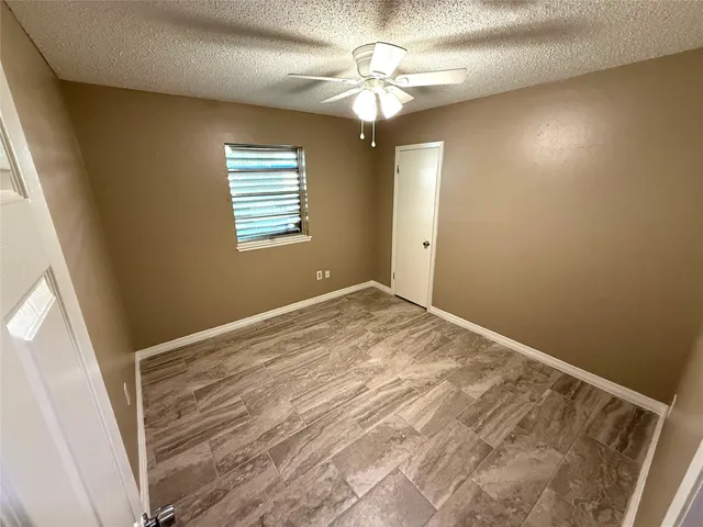 a view of room with window and ceiling fan
