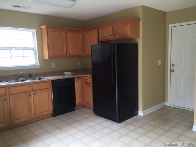 7800 Rabbits Foot Lane Charlotte, NC 28217 - Photo 7 of 9 a kitchen with a refrigerator and cabinets