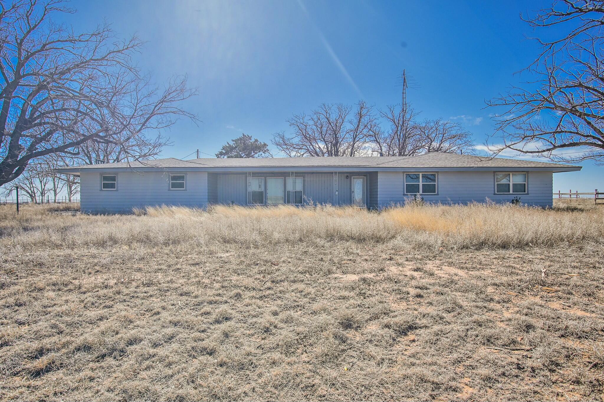 a view of swimming pool of water and brick building in the background