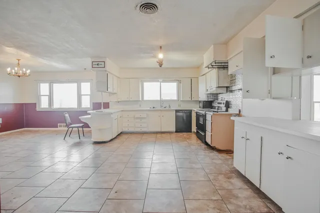 a view of an empty room with a cabinet