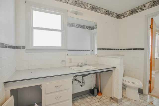 a bathroom with a shower and a glass door