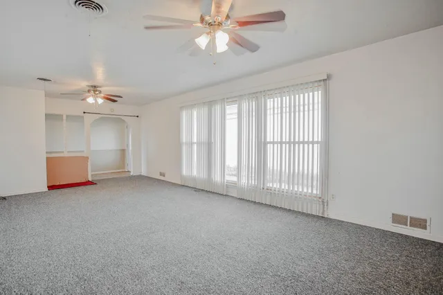 a view of empty room with a ceiling fan
