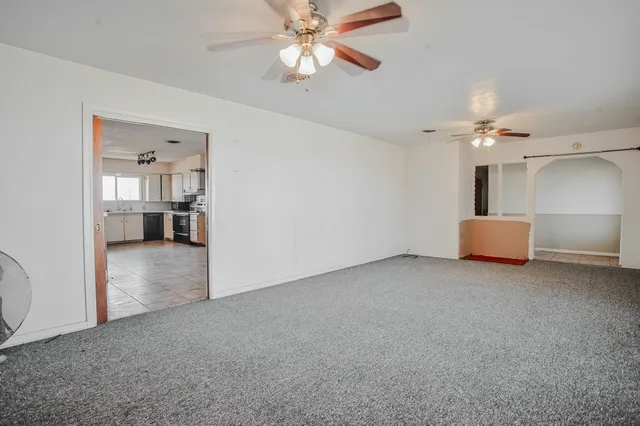 a view of an empty room with a fireplace and a window