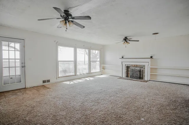 a view of an empty room with a fireplace
