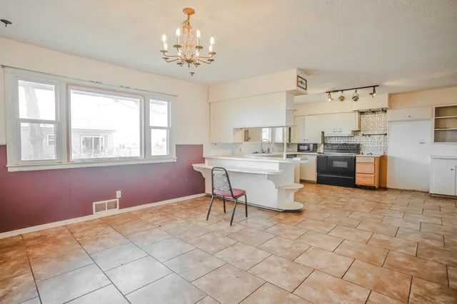a kitchen with a stove a sink and a refrigerator