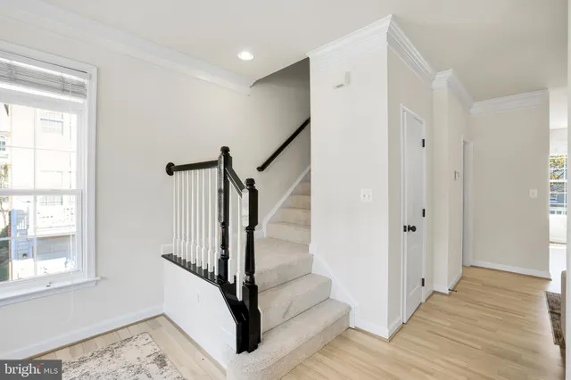 a view of entryway with wooden floor and stairs