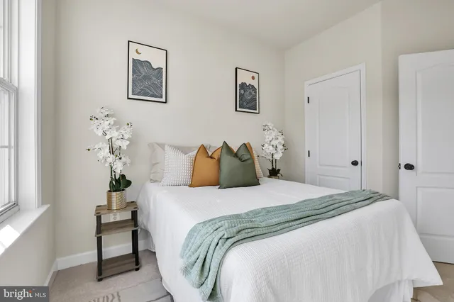 a bedroom with a bed and a lamp