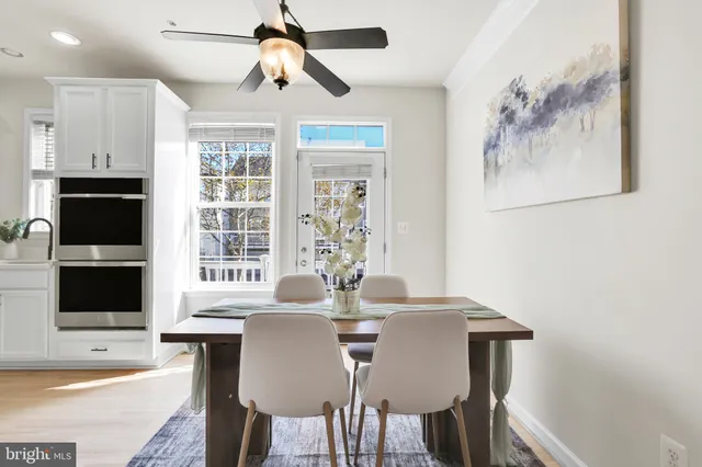 a view of a dining room with furniture and wooden floor