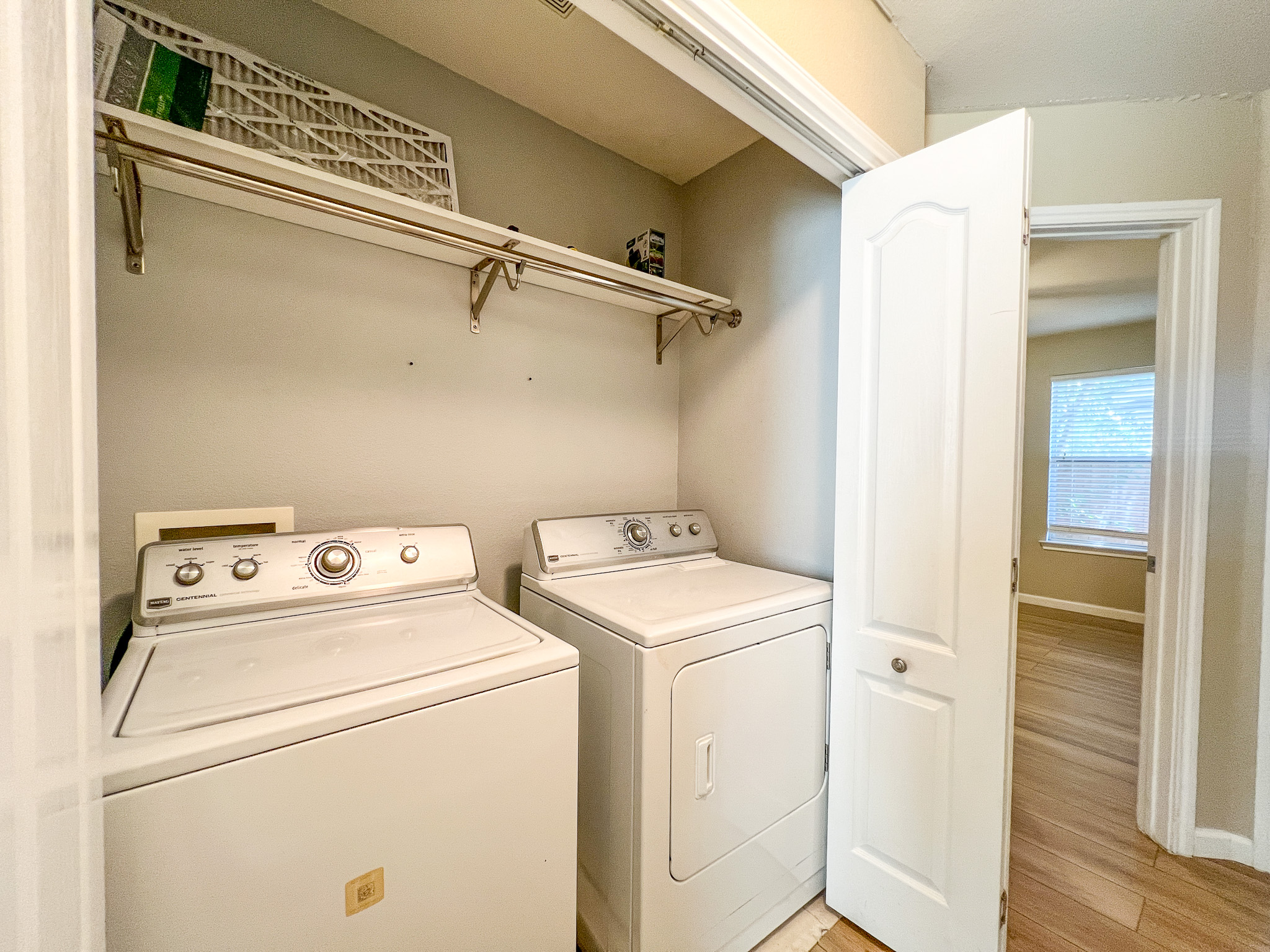 298 Jack Rabbit Lane Buda, TX 78610 - Photo 2 of 24 Functional laundry area featuring convenient shelving and essential appliances.