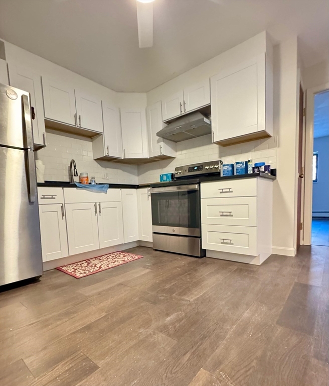 15 Walbridge Street, Unit 23 Boston, MA 02134 - Photo 2 of 14 a kitchen with stainless steel appliances granite countertop a stove a sink and a refrigerator