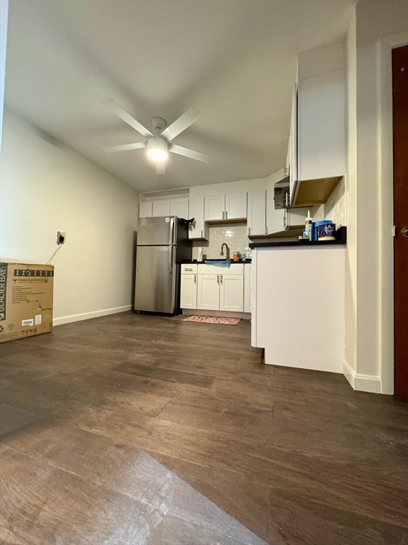 15 Walbridge Street, Unit 23 Boston, MA 02134 - Photo 3 of 14 a kitchen with kitchen island a counter top space a sink and cabinets