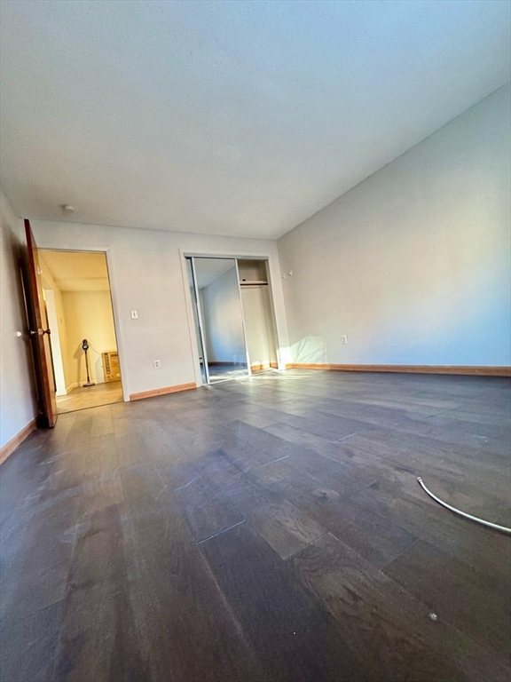 15 Walbridge Street, Unit 23 Boston, MA 02134 - Photo 5 of 14 a view of empty room with wooden floor