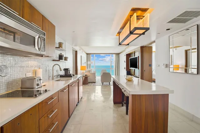 a large kitchen with stainless steel appliances granite countertop a sink and dishwasher a oven with wooden cabinets