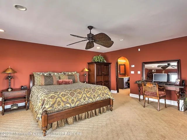 a spacious bedroom with a large bed and a large window