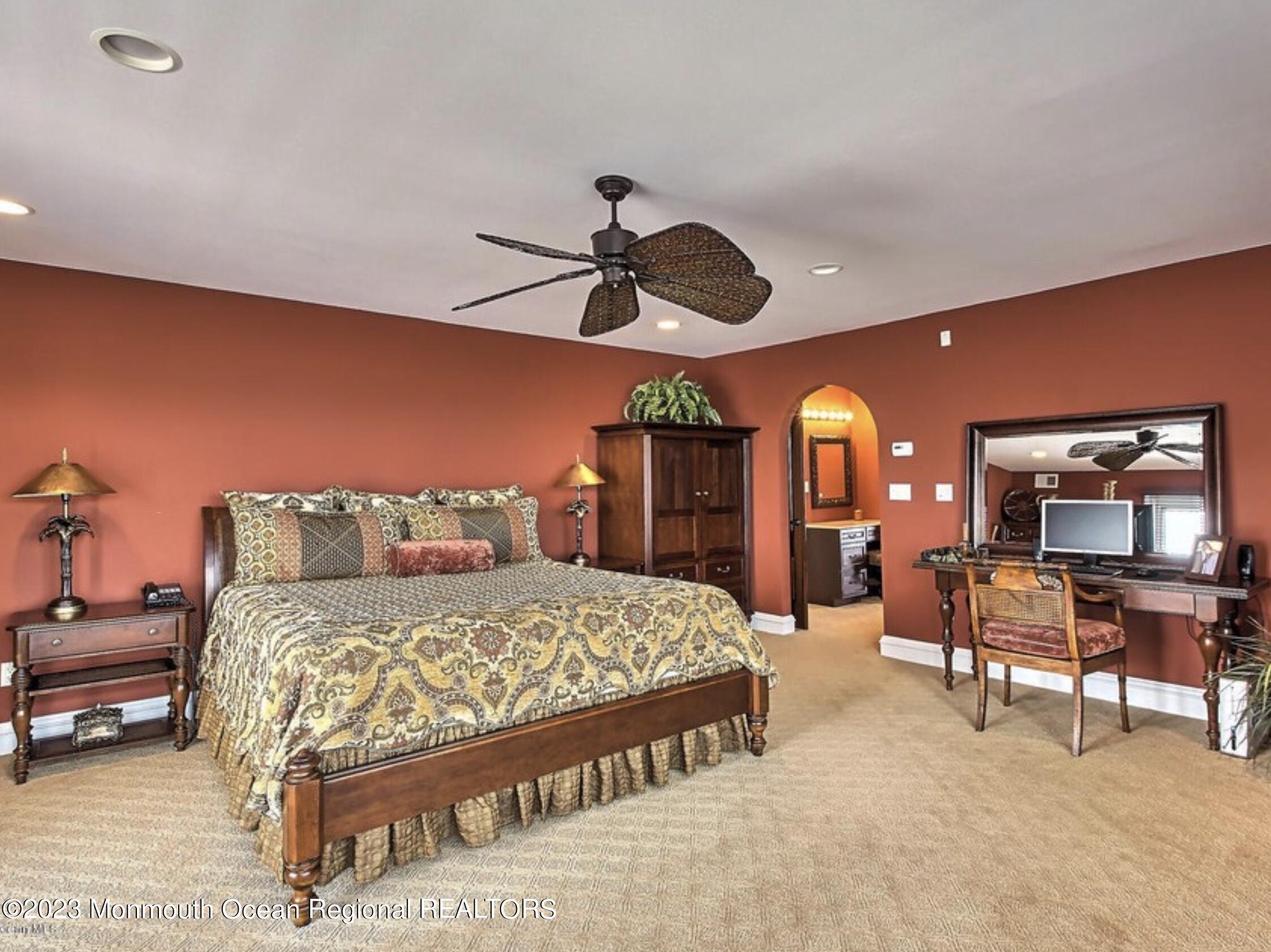 220 Pointe Drive Mantoloking, NJ 08738 - Photo 13 of 30 a bedroom with a bed and a chandelier