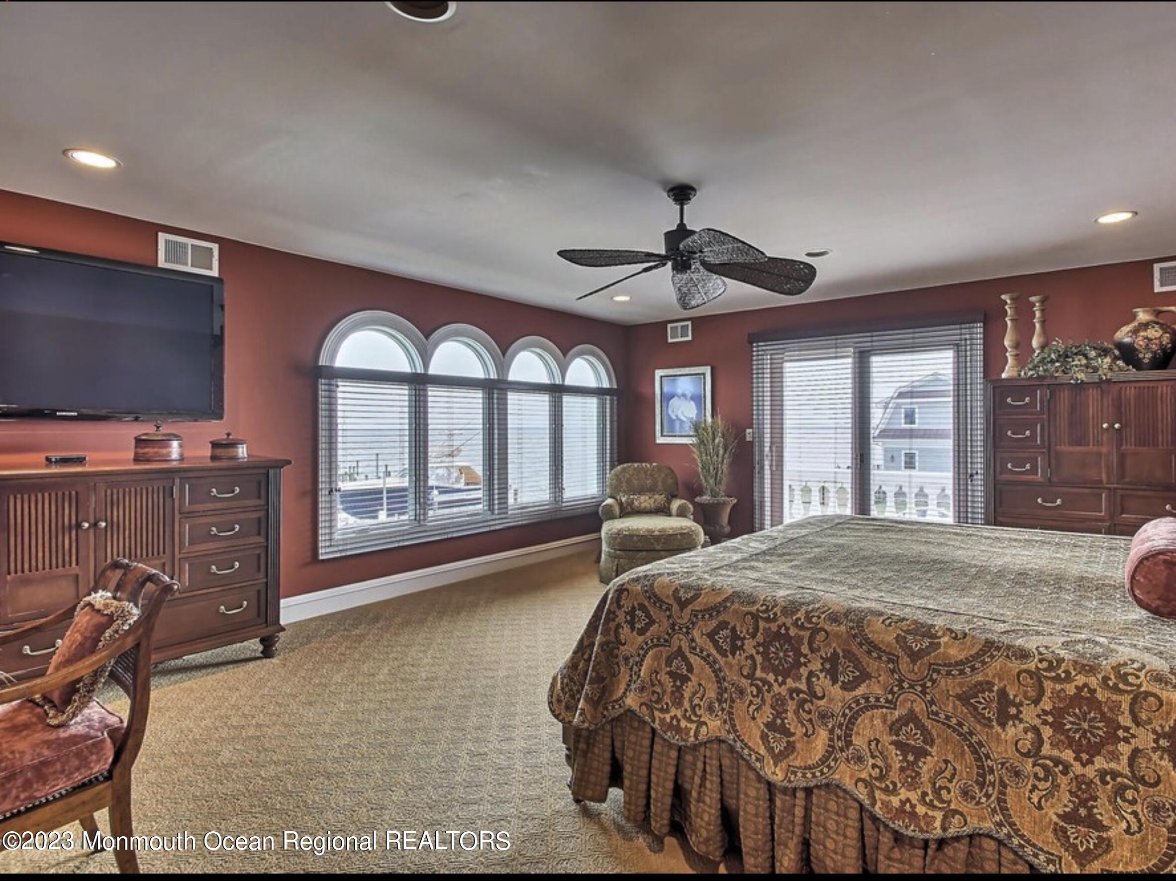 220 Pointe Drive Mantoloking, NJ 08738 - Photo 14 of 30 a spacious bedroom with a large bed and a large window