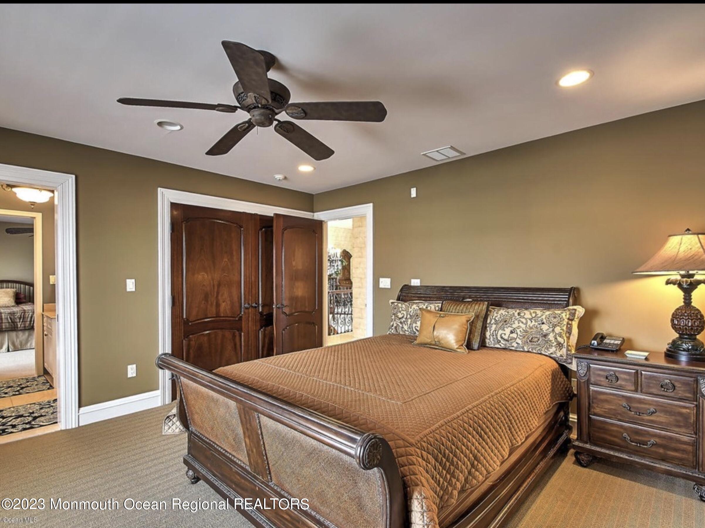 220 Pointe Drive Mantoloking, NJ 08738 - Photo 16 of 30 a bed room with a bed and a ceiling fan