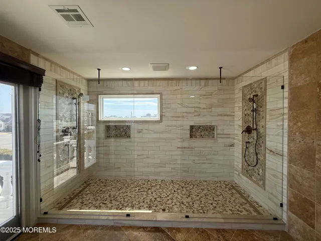 a bathroom with a double vanity sink toilet and shower